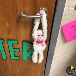 stuffed monkey hanging on door