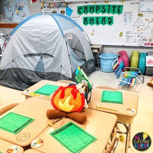 camping classroom transformation tent with campfire and sign on board that says campsite ahead