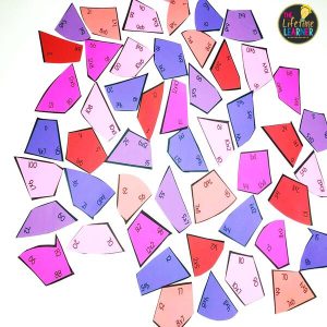 valentine puzzle pieces scattered around with math facts on them