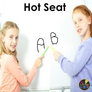two students pointing to answers on whiteboard